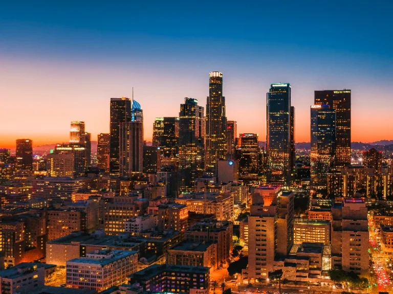 Downtown city skyline at sunset, showcasing that the company does water damage restoration emergency in Los Angeles.